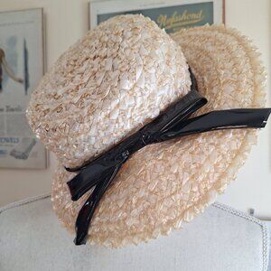 Vintage natural colored straw hat with a glossy finish and vinyl black ribbon
